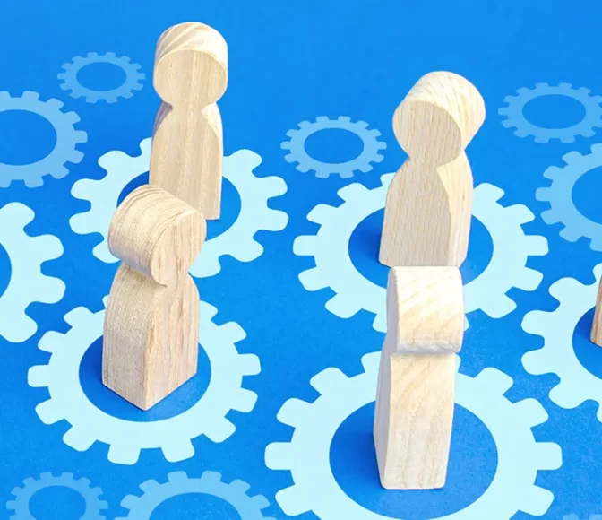 Symbolic player pieces collect with gears to demonstrate teamwork being achieved through effective training